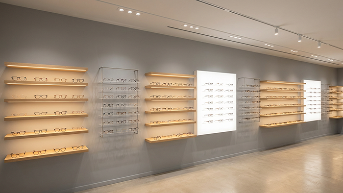 Sala de exposición de monturas ópticas de IU Eyewear que muestra monturas de gafas de acetato, metal y TR90 de primera calidad
